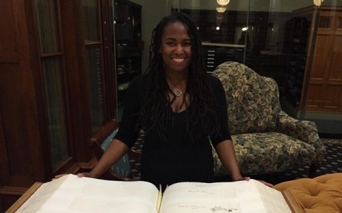 Rare Books Librarian Maria Cunningham with the 50 lb. Autograph Book. Photo by Jim Higgins.