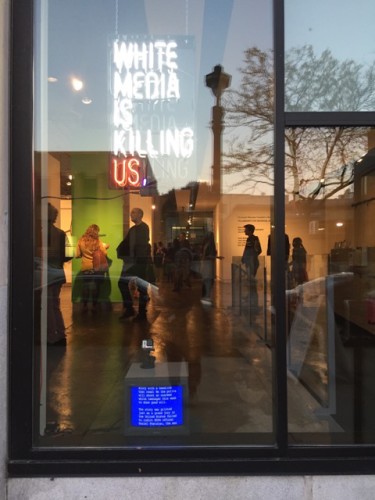 A neon sign and looping video message, part of Knapp's exhibit, at the entrance to the gallery.