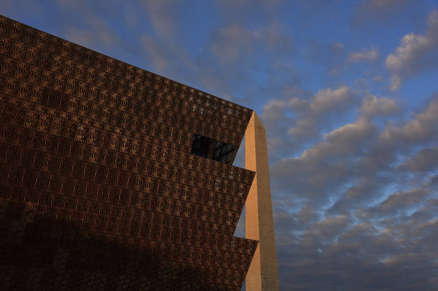 The morning sun paints the Washington Monument red as it skims the top of the National Museum of African American History and Culture - NMAAHC  in Washington, DC.  The new museum opened to the public September 24, 2016.  When viewed from particular angles, the two structures fit together like puzzle pieces.
(Photo by Jahi Chikwendiu/The Washington Post via Getty Images)