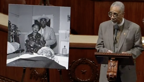 Anti Lynching Law Rep. Bobby Rush stands on the U.S. House floor next to a photograph of Mamie Till and her future husband, Gene Mobley, as she views her son Emmett's body. R (Image is a still from C-SPAN video.)