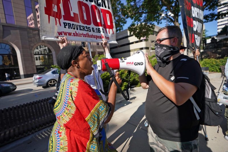 A woman confronts a group at Red Arrow Park