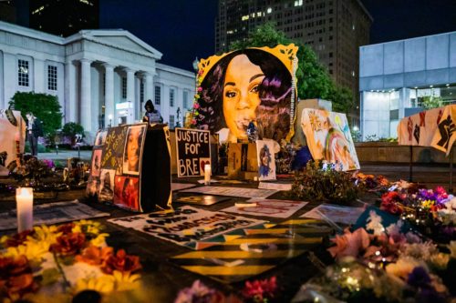 A mural of Breonna Taylor in the night.