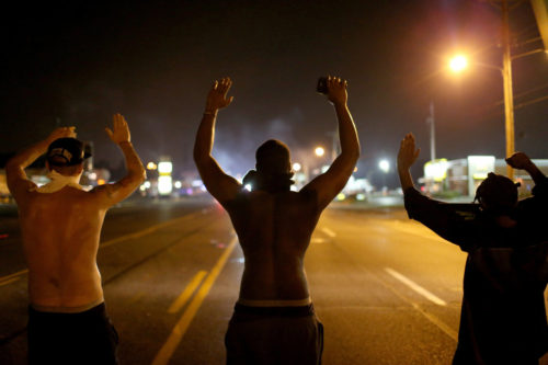 protestors raise their hands