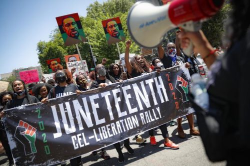 June 19, 2020. Protesters chant as they march after a Juneteenth rally at the Brooklyn Museum, in the Brooklyn borough of New York. (AP Photo/John Minchillo, File)