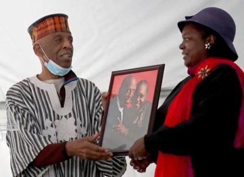 Reuben Harpole and his daughter with a photo of Reuben and his late wife Mildred, both celebrated community activists.