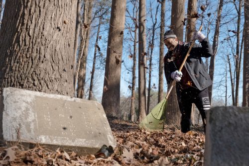 Michael Williams, a descendant of one of the African American families buried in Geer Cemetery, helps clean up the cemetery with community volunteers in Durham, N.C.Cornell Watson for NBC News