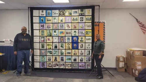 George Alfred (left) and Pearly Alfred stand next to the Heritage Quilt (African American Heritage Foundation)