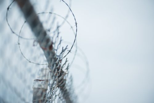 Barbed wire and fencing (Erik Mclean/Pexels)