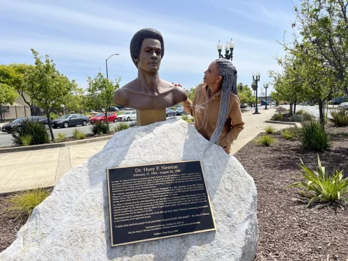 Fredrika Newton stands next to the bust of her late husband, Black Panther co-founder Huey P. Newton. (Marisa Penaloza/NPR)