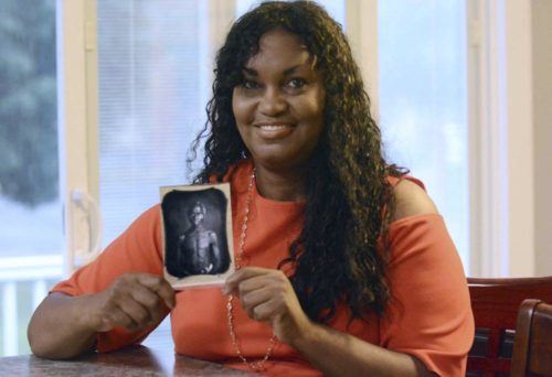 Tamara Lanier holding a photo of her family's patriarch, Renty. The photo was taken in 1850. (John Shishmanian/The Norwich Bulletin via AP, File)