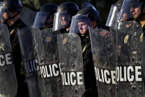 Phoenix Police officers watch protesters rally on June 2, 2020, during demonstrations over the death of George Floyd. (Matt York / AP file)