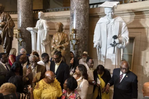 Mary McLeod Bethune,'s granddaughter Evelyn, in yellow, speaks with Rep. Sheila Jackson Lee, D-Texas during the unveiling of the statue of her grandmother on July 13, 2022. (Jacquelyn Martin / AP)