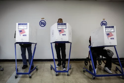 Voters in temporary voting booths (Anna Watts for The New York Times)