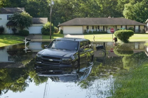 An SUV rests in floodwaters in northeast Jackson, Miss., on Monday. (Rogelio V. Solis / AP)