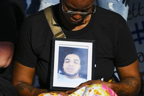 Donovan Lewis' girlfriend holds his picture during a rally at the Columbus Division of Police headquarters on Sept. 2. (Gaelen Morse / Getty Images)