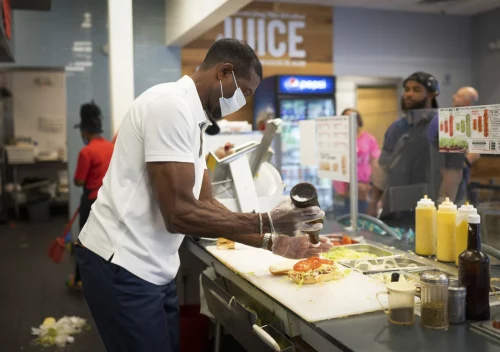 Keith Millner, a co-owner of a Jersey Mike's sandwich shop in Atlanta, works behind the counter Saturday. (Rita Harper for NBC News)