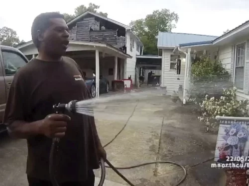 Michael Jennings was watering a neighbor's flowers when the cops showed up and placed him under arrest. (Childersburg Police Department via AP)