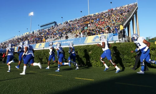 Members of the Hampton University football team take the field at Delaware Stadium in Wilmington, Del., in 2022. (William Bretzger / Delaware News Journal / USA TODAY NETWORK file)