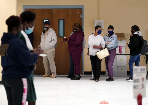 People line up to vote in New Orleans in Nov 2020. (Gerald Herbert / AP file)