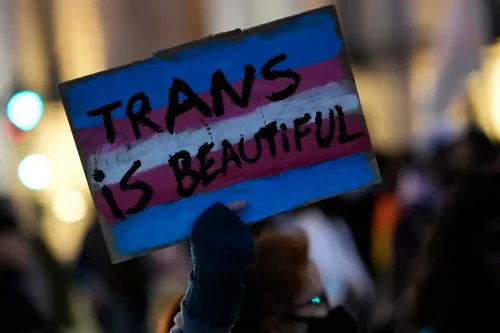 A demonstrators holds up a sign during a march to mark International Transgender Day of Visibility in Lisbon, Thursday, March 31, 2022.