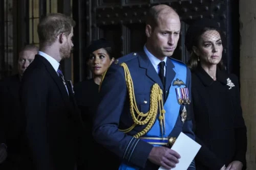 Prince Harry and Meghan walk behind Prince William and Princess Kate after paying their respects to Queen Elizabeth II in September. (Emilio Morenatti / AP file)