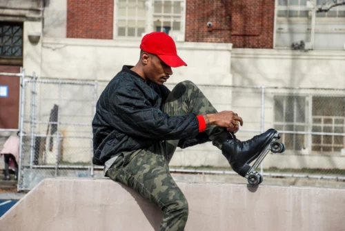 Harry Martin, the founder of The Roller Wave, laces up his skates in a Harlem park. (Janie Barber / The Roller Wave)