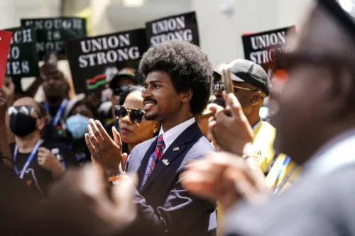 Tennessee state Rep. Justin Pearson, D-Memphis, center, listens during a speech at the "Teach No Lies" march Wednesday outside the Miami-Dade County School Board in Miami. Lynne Sladky / AP