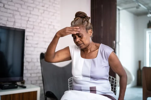 A Black woman clutches her head. (FG Trade via Getty)