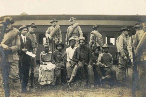 Teenagers Oscar Daniel, seated, second from left, and Ernest Knox, seated, far right, were hanged in Forsyth County, Ga., as part of a dayslong campaign to expel all Black people from the area in September 1912. (Kenan Research Center at Atlanta History Center)