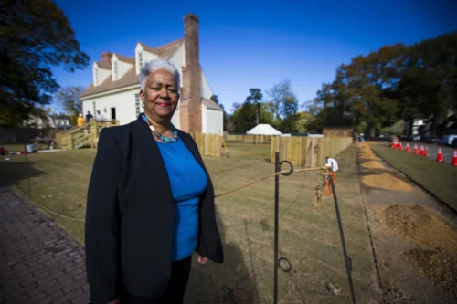 Janice Canaday, Colonial Williamsburg Foundations African American community engagement manager, stands outside near the Williamsburg Bray School on Wednesday, October 30, 2024 in Williamsburg, VA. (AP Photo/John C. Clark)