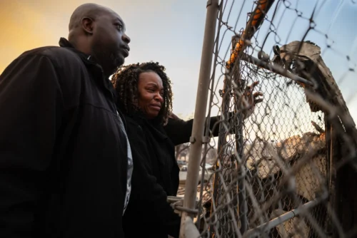 A couple looks at the charred remains of their home burned in the Eaton Fire in Altadena, California, January 9, 2025. Massive wildfires that engulfed whole neighborhoods and displaced thousands in Los Angeles remained totally uncontained January 9, 2025, authorities said, as US National Guard soldiers readied to hit the streets to help quell disorder. Swaths of the United States' second-largest city lay in ruins, with smoke blanketing the sky and an acrid smell pervading almost every building. (ZOE MEYERS/AFP via Getty Images)