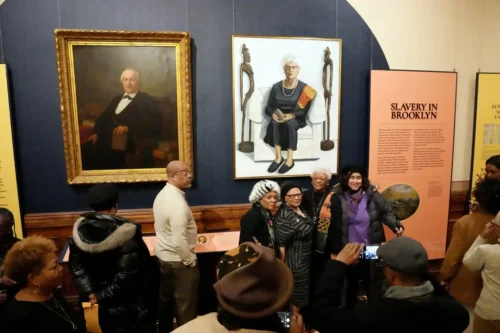 A portrait of John A. Lott, left, and Mildred Jones, a descendant of a man enslaved by the Lott family, anchor a new exhibition at the Center for Brooklyn History. (Michelle V. Agins/The New York Times)