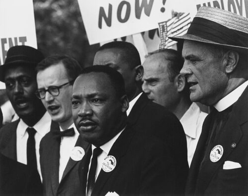 Civil_Rights_March_on_Washington,_D.C._(Dr._Martin_Luther_King,_Jr._and_Mathew_Ahmann_in_a_crowd.)_-_NARA_-_542015_-_Restoration Martin Luther King Jr. during the 1963 March on Washington for Jobs and Freedom, during which he delivered his historic "I Have a Dream" speech, calling for an end to racism.