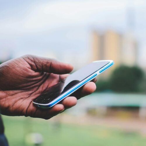 190 Person Holding Blue Smartphone (Mwabonje Ringa)