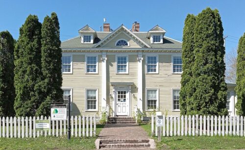 Longfellow house with tall columns and surrounded by trees