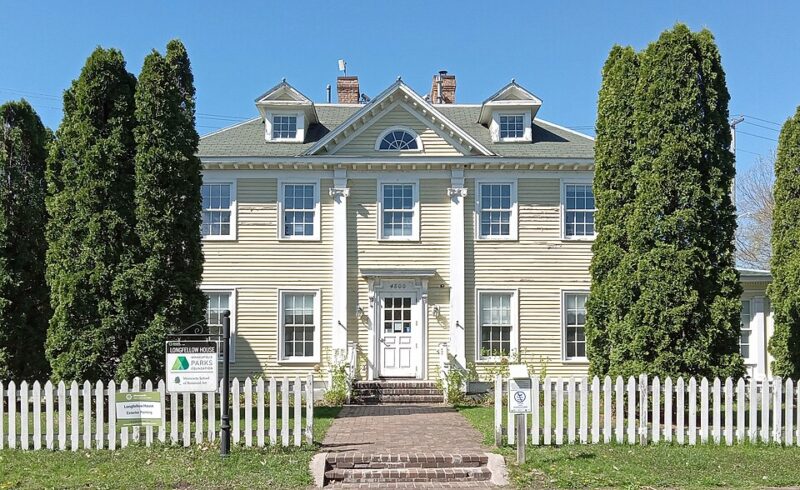 Longfellow house with tall columns and surrounded by trees
