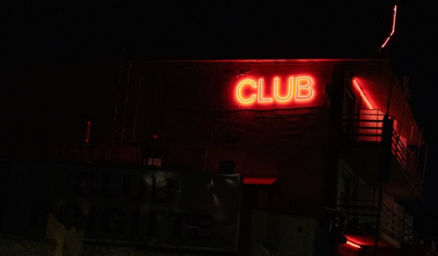 Neon club sign lit up at night