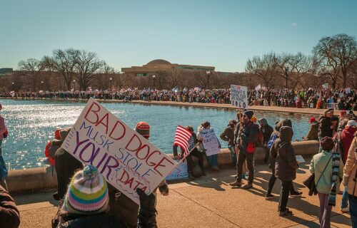 2025.02.17_No_Kings_Day_Protest,_Washington,_DC_USA_048_52108 Protestors with signs near the U.S. Capitol Reflecting Pool