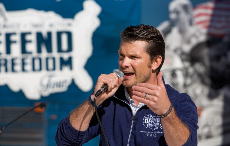 Pete Hegseth speaking into a microphone