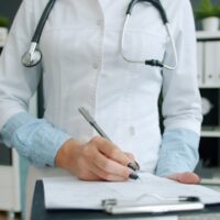 Person in medical writing on a form