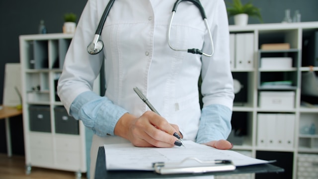 Person in medical writing on a form