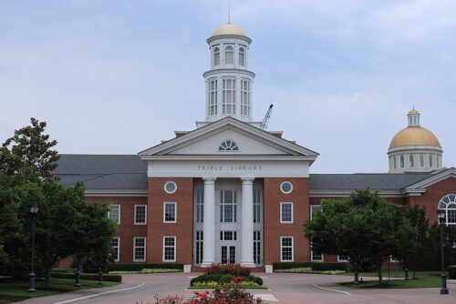Stately brick building with white columns housing the library at Christopher Newport University